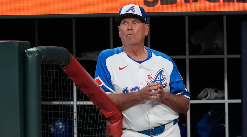 Atlanta Braves manager Brian Snitker (43) watches from the dugout during a baseball game against the Texas Rangers Saturday, April 20, 2024, in Atlanta. (AP Photo/John Bazemore)