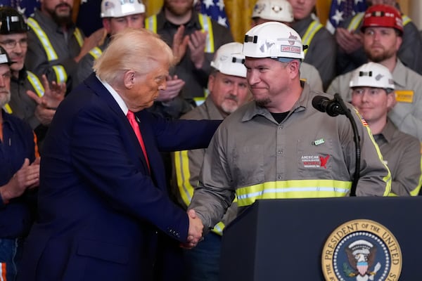 President Donald Trump shakes hands with coal miner Jeff Crowe during an event on energy production in the East Room of the White House, Tuesday, April 8, 2025, in Washington. (AP Photo/Alex Brandon)