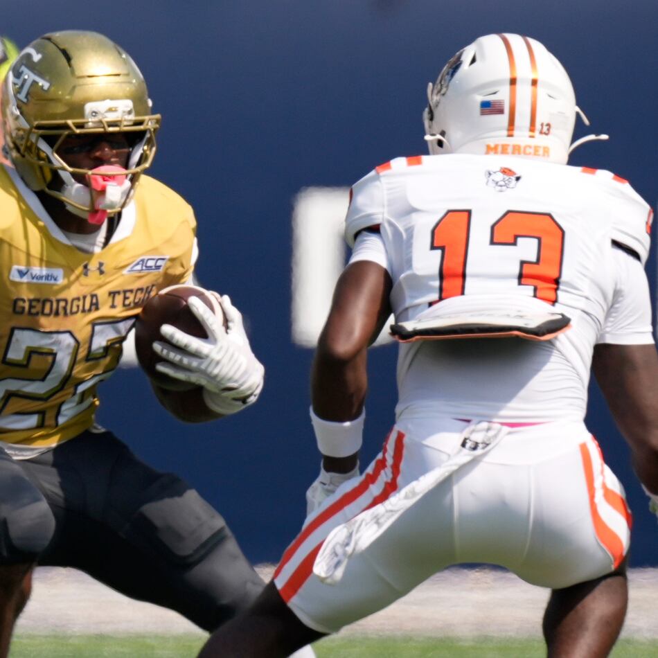 Georgia Tech running back Justice Haynes (22) runs against Mercer safety Mike Polke (13) in the first half of an NCAA college football game, Saturday, Sept. 19, 2026, in Atlanta. (AP Photo/Mike Stewart)