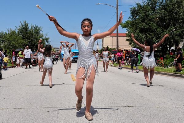 Kids participate in a Juneteenth parade Thursday, June 19, 2025, in Galveston, Texas. (AP Photo/David J. Phillip)