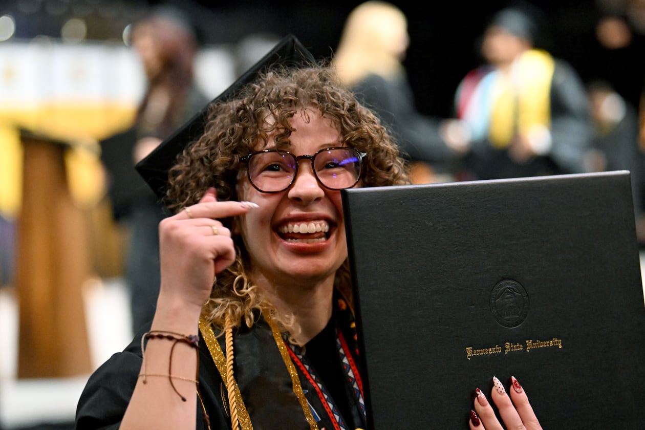 A Kennesaw State graduate is all smiles after receiving her diploma during the niversity’s 2026 sping commencement May 13, 2026. Wednesday's ceremony included the College of Architecture and Construction Management, and the Michael J. Coles College of Business (undergraduate students in entrepreneurship, hospitality, management, marketing and professional sales). (Hyosub Shin/AJC)