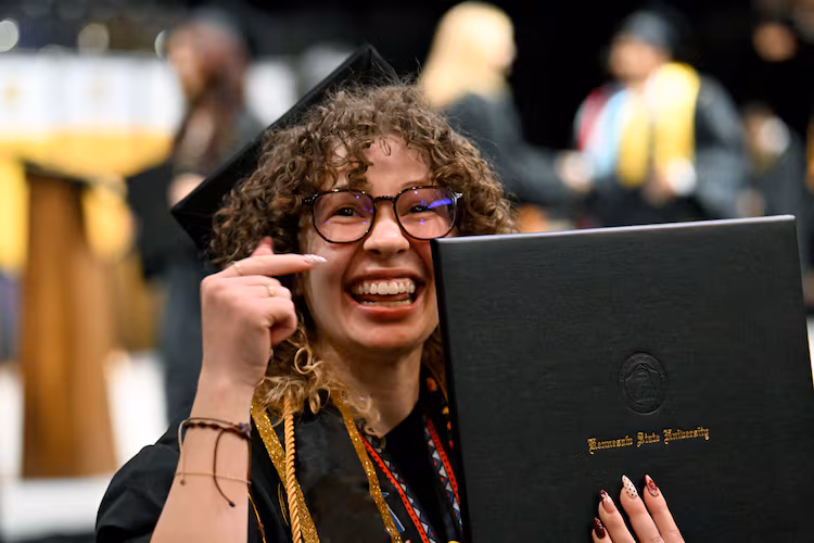 A Kennesaw State graduate is all smiles after receiving her diploma during the niversity’s 2026 sping commencement May 13, 2026. Wednesday's ceremony included the College of Architecture and Construction Management, and the Michael J. Coles College of Business (undergraduate students in entrepreneurship, hospitality, management, marketing and professional sales). (Hyosub Shin/AJC)