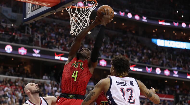 Paul Millsap of the Atlanta Hawks puts up a shot between Marcin Gortat and Kelly Oubre Jr. of the Washington Wizards in the second half in Game 5 of the Eastern Conference quarterfinals at Verizon Center on April 26, 2017 in Washington, DC. (Photo by Rob Carr/Getty Images)