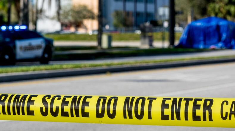 Police tape is stretched outside of Marjory Stoneman Douglas High School at the corner of Holmberg Road and Coral Springs Drive in Parkland.