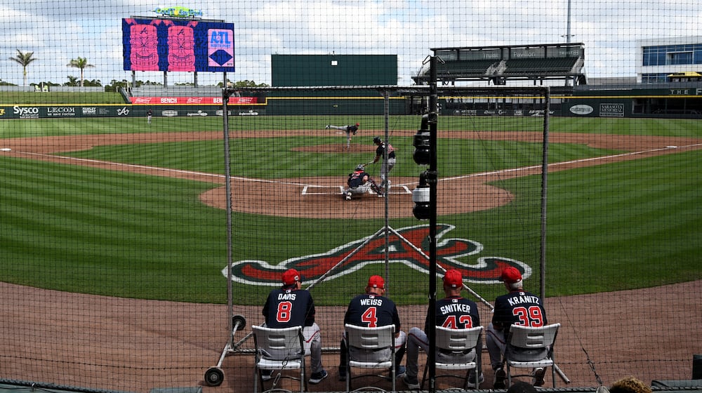 Atlanta Braves then-manager Brian Snitker and other coaches watch batting practice during February's first full-squad spring training workout at CoolToday Park in Florida. (Hyosub Shin/AJC)