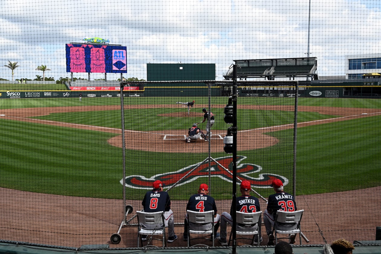 Atlanta Braves then-manager Brian Snitker and other coaches watch batting practice during February's first full-squad spring training workout at CoolToday Park in Florida. (Hyosub Shin/AJC)