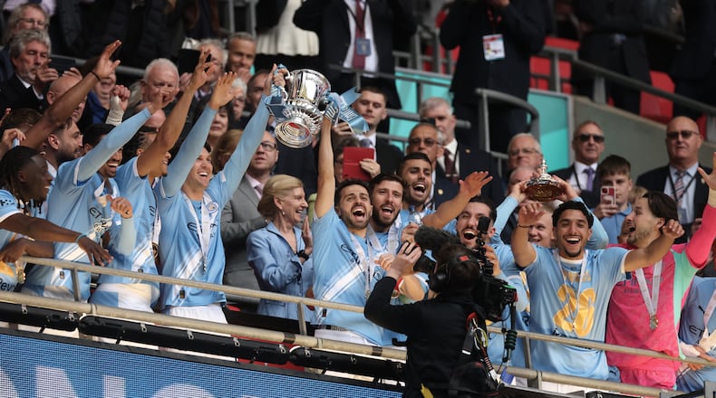 Manchester City players celebrate with the winner's trophy after the English FA Cup final soccer match between Chelsea and Manchester City in London, Saturday, May 16, 2026. (AP Photo/Richard Pelham)