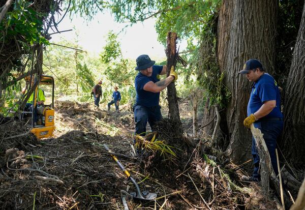 La Salle County Fire Rescue firefighters do search and rescue work on the banks of the Guadalupe River in Ingram, Texas, Tuesday, July 8, 2025, after the Fourth of July flood. (Jay Janner/Austin American-Statesman via AP)