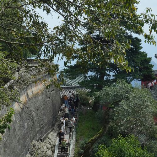Visitors walk near a temple in Wudang Mountains in central China's Hubei Province on Sept. 3, 2026. (AP Photo/Achmad Ibrahim)