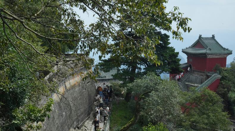 Visitors walk near a temple in Wudang Mountains in central China's Hubei Province on Sept. 3, 2026. (AP Photo/Achmad Ibrahim)