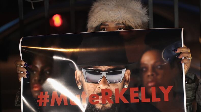 Demonstrators gather Jan. 9, 2019, in Chicago near the studio of singer R. Kelly to call for a boycott of his music after allegations of sexual abuse against young girls were raised on the Lifetime miniseries “Surviving R. Kelly.” Prosecutors in Illinois and Georgia have opened investigations into allegations made against the singer, whose real name is Robert Sylvester Kelly. SCOTT OLSON / GETTY IMAGES