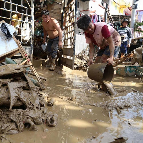 Residents clean up outside their homes after Typhoon Kalmaegi caused devastation in communities at Talisay City, Cebu province, central Philippines, Wednesday, Nov. 5, 2025. (AP Photo/Jacqueline Hernandez)