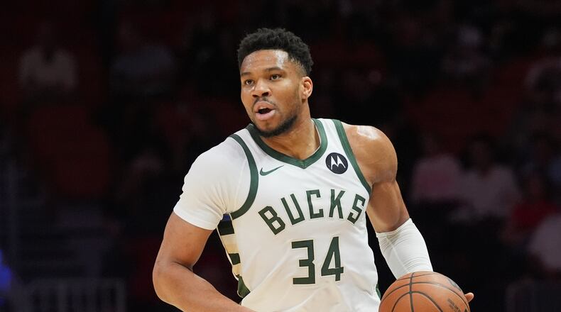 FILE - Milwaukee Bucks forward Giannis Antetokounmpo (34) dribbles the ball during the first half of an NBA basketball game against the Miami Heat, March 12, 2026, in Miami. (AP Photo/Marta Lavandier, File)