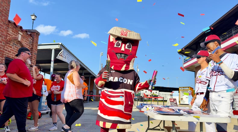 Mascot "Kevin Bacon" greets Macon Bacon fans at Luther Williams Field on opening night in Macon, Georgia. The Macon Bacon team plays in a collegiate baseball summer league. (Joe Kovac Jr. / AJC)