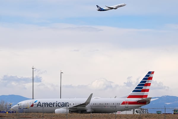 FILE - An American Airlines jetliner that caught fire after landing the previous day at Denver International Airport sits near a hangar at the airport, March 14, 2025, in Denver. (AP Photo/David Zalubowski, File)