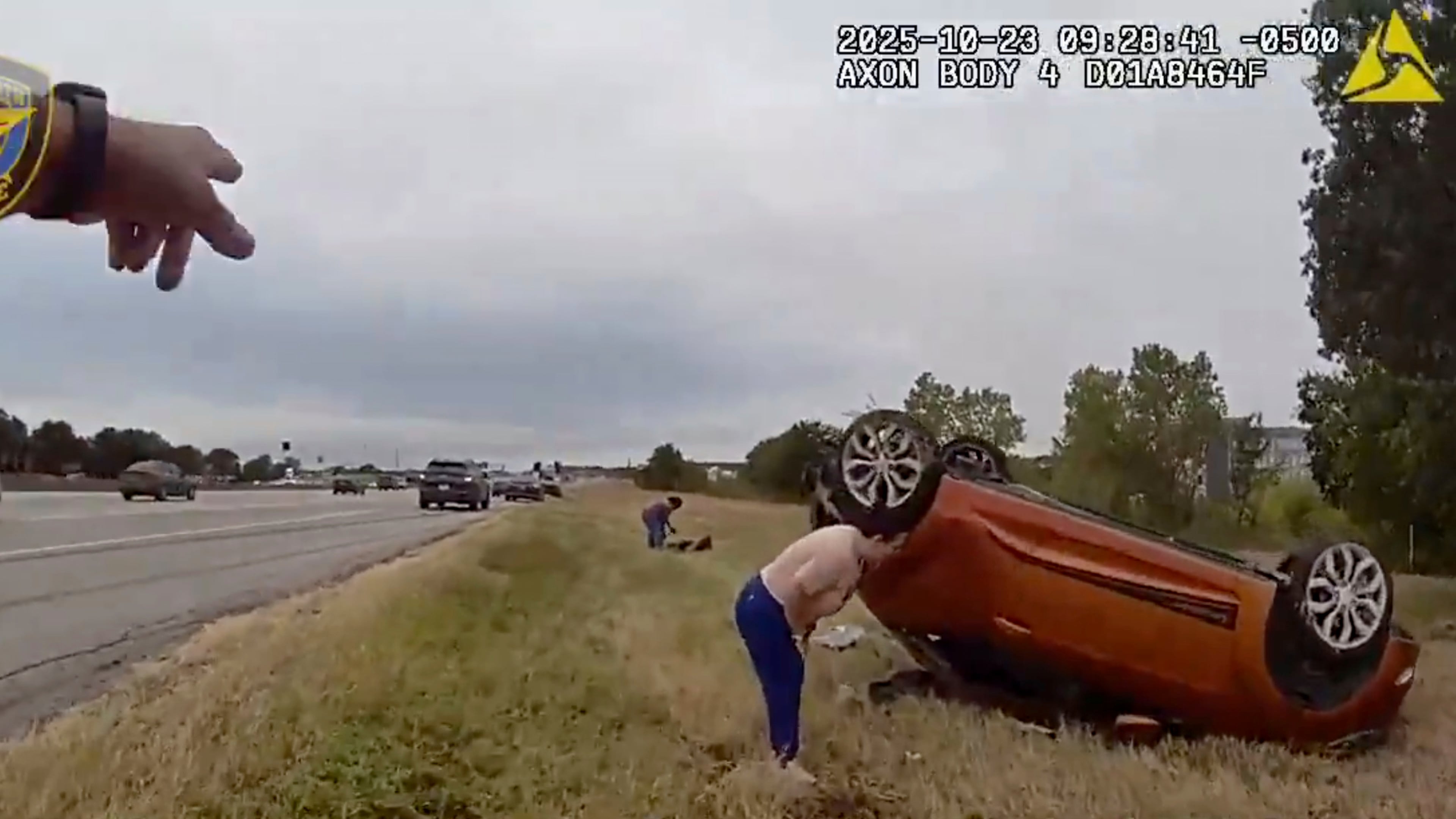 This image taken from video released by the Fort Worth Police Department shows officers responding to an overturned car before pulling a baby out from underneath Thursday, Oct. 23, 2025, in Fort Worth, Texas. (Fort Worth Police Department via AP)