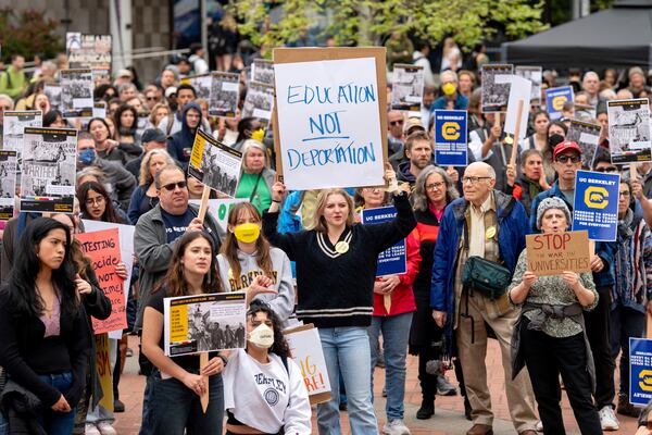 University of California, Berkeley undergraduate Eva Winter holds a sign over her head while protesting against the Trump administration during a Day of Action for Higher Education on Thursday, April 17, 2025, in Berkeley, Calif. (AP Photo/Noah Berger)
