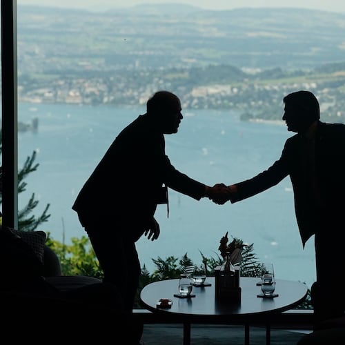 Delegation staff members meet in the lobby on the first day of a quadrilateral meeting between the U.S., Iran, Pakistan, and Qatar at the Buergenstock Resort Lake Lucerne, near Stansstad, Switzerland, Sunday, June 21, 2026. (Nathan Howard/Pool Photo via AP)