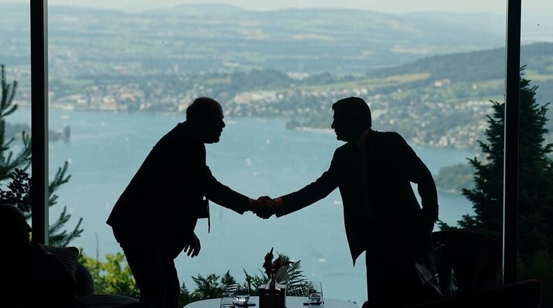 Delegation staff members meet in the lobby on the first day of a quadrilateral meeting between the U.S., Iran, Pakistan, and Qatar at the Buergenstock Resort Lake Lucerne, near Stansstad, Switzerland, Sunday, June 21, 2026. (Nathan Howard/Pool Photo via AP)