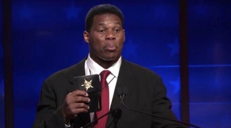 Herschel Walker pulls out a badge at his debate with U.S. Sen. Raphael Warnock.