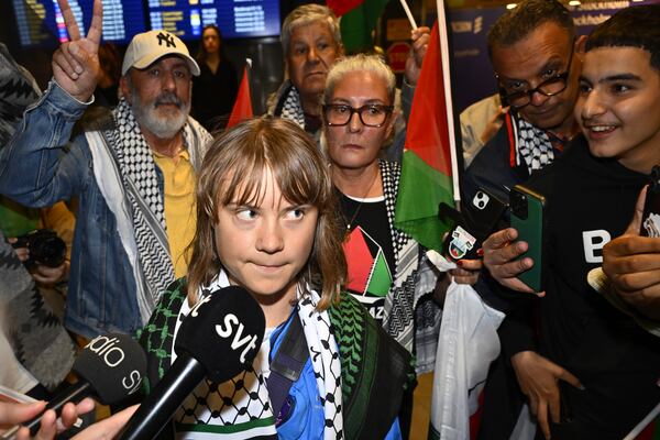 Swedish activist Greta Thunberg talks to journalists as she arrives at Stockholm Arlanda Airport outside Stockholm, Sweden, Tuesday June 10, 2025. (Anders Wiklund/TT News Agency via AP)