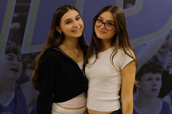Twin sisters Kayla Jasser, left, and Sydney Jasser attend rehearsal for Plainview-Old Bethpage John F. Kennedy High School's graduation ceremony at Hofstra University in Hempstead, N.Y., on Tuesday, June 17, 2025. (AP Photo/Philip Marcelo)