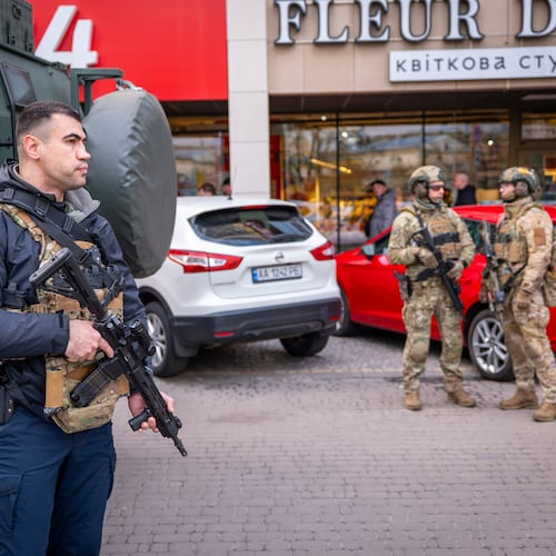 Police officers are seen at the site where a gunman killed at least six people in the streets before being shot dead by police, in Kyiv, Ukraine, Saturday, April 18, 2026. (AP Photo/Dan Bashakov)