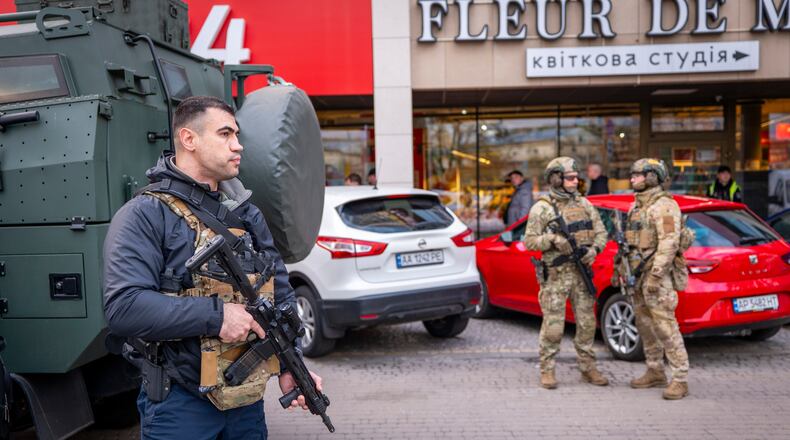 Police officers are seen at the site where a gunman killed at least six people in the streets before being shot dead by police, in Kyiv, Ukraine, Saturday, April 18, 2026. (AP Photo/Dan Bashakov)