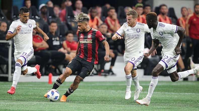 Atlanta United Josef Martinez works the ball through three Orlando City defenders during the first half in a MLS soccer match on Saturday, June 30, 2018, in Atlanta.     Curtis Compton/ccompton@ajc.com