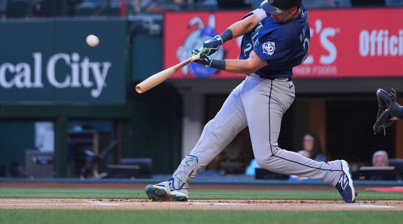 Seattle Mariners' Cal Raleigh connects on a solo home run off Texas Rangers starting pitcher Jacob deGrom during the first inning of a baseball game Monday, April 6, 2026, in Arlington, Texas. (AP Photo/Julio Cortez)