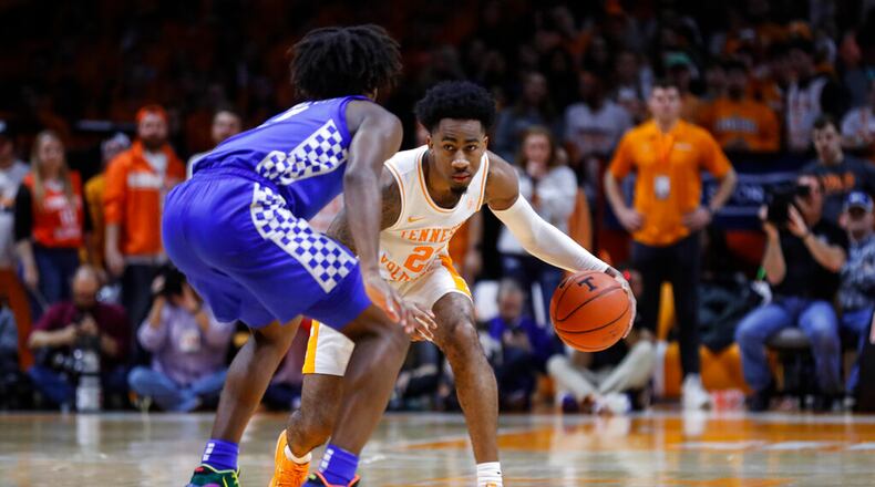 Tennessee guard Jordan Bowden (23) works the ball as he's defended by Kentucky guard Immanuel Quickley (5) during an NCAA college basketball game Saturday, Feb. 8, 2020, in Knoxville, Tenn. Kentucky won 77-64. (AP Photo/Wade Payne)