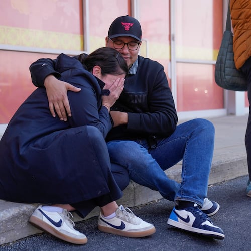 Maria Guzman, left, and Sergio Rocha, parents of young children, comfort each other outside of Rayito de Sol Spanish Immersion Early Learning Center after an employee of the preschool was arrested by federal immigration agents, Wednesday, Nov. 5, 2025, in Chicago. (AP Photo/Erin Hooley)