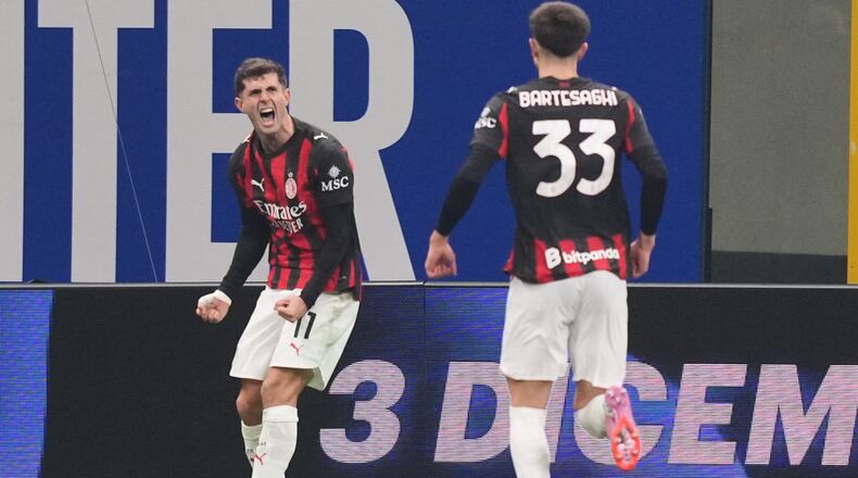 AC Milan's Christian Pulisic celebrates after scoring during the Serie A soccer match between Inter Milan and AC Milan in Milan, Italy, Sunday, Nov. 23, 2025. (AP Photo/Antonio Calanni)