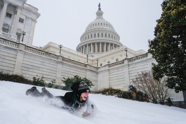 Emilia O'Brien of Michigan enjoyed the snow outside of the U.S. Capitol on Sunday. ( Julia Demaree Nikhinson/AP)