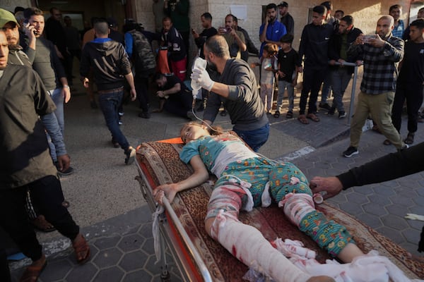 A Palestinian girl wounded in an Israeli airstrike on a school in Bureij refugee camp is brought to Al-Aqsa Martyrs Hospital in Deir al Balah, central Gaza Strip, on Tuesday, May 6, 2025. (AP Photo/Abdel Kareem Hana)