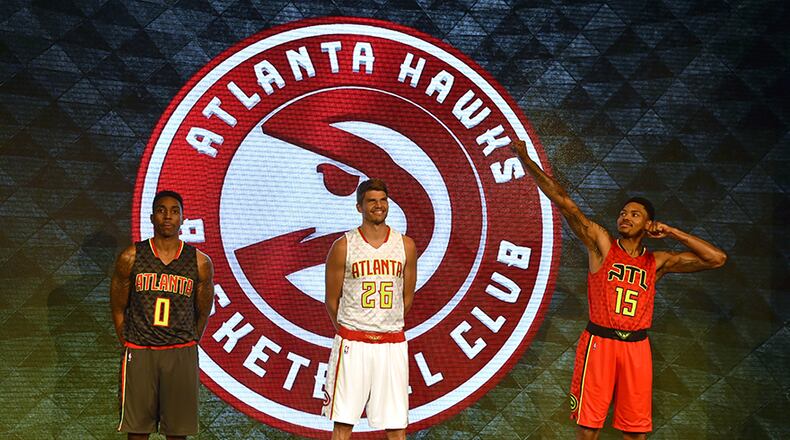The Atlanta Hawks unveil their new uniforms at a press conference Wednesday at Philips Arena. Road uniform on the left, worn by Jeff Teague, home uniform in the center worn by Kyle Korver and the alternate road uniform on the right, worn by Ken Bazemore.