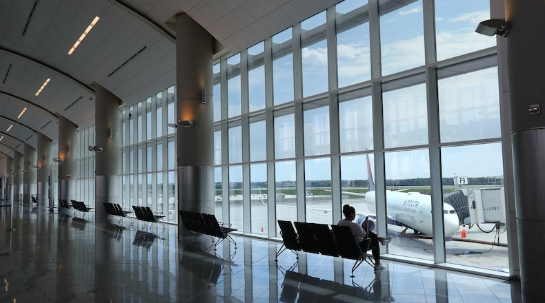 Nalim Nunes had the ticket area of Atlanta Hartsfield-Jackson’s international terminal to herself while waiting on her Delta Air Lines flight home to Brazil from Atlanta on Monday, March 30, 2020. Nunes is a hospitality worker at a Charleston hotel and decided to return home after her job was lost because of the coronavirus pandemic. Curtis Compton ccompton@ajc.com