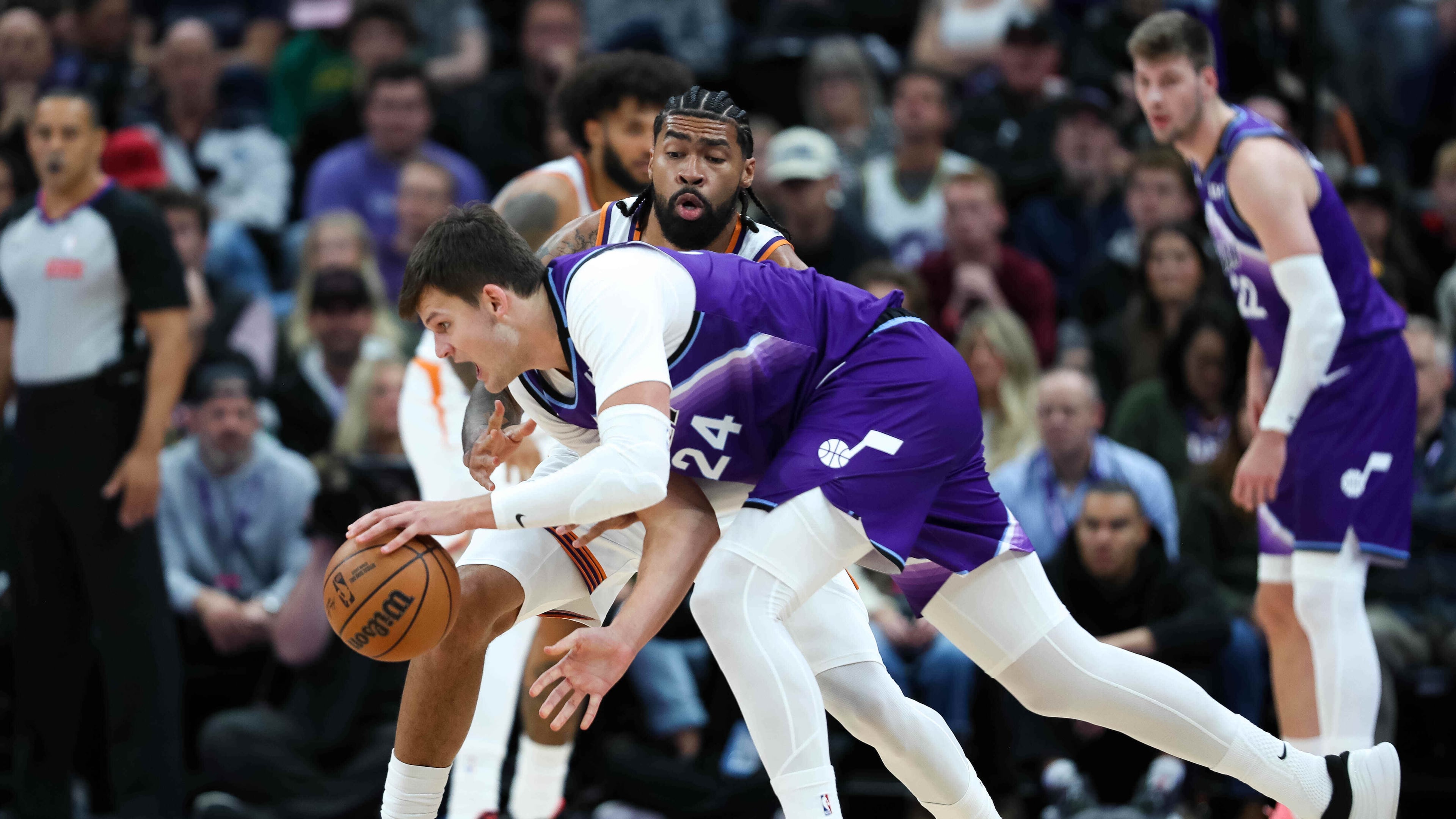 Phoenix Suns center Nick Richards, top, defends against Utah Jazz center Walker Kessler (24) during the first half of an NBA basketball game, Monday, Oct. 27, 2025, in Salt Lake City. (AP Photo/Anna Fuder)