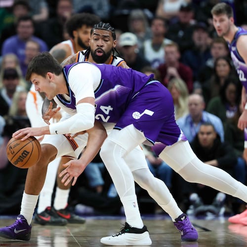 Phoenix Suns center Nick Richards, top, defends against Utah Jazz center Walker Kessler (24) during the first half of an NBA basketball game, Monday, Oct. 27, 2025, in Salt Lake City. (AP Photo/Anna Fuder)