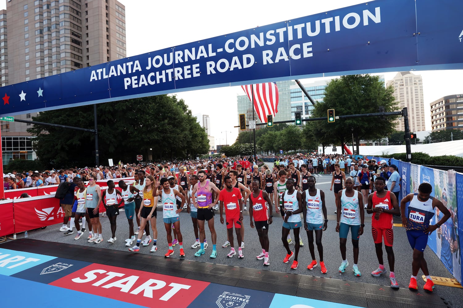 Elite men runners get in pace at the start of the 56th running of The Atlanta Journal-Constitution Peachtree Road Race in Atlanta on Friday, July 4, 2025.   (Arvin Temkar/AJC)