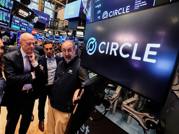 Jeremy Allaire, , left, Co-Founder, Chairman & CEO of Circle, listens to specialist Peter Giacchi, right, before the IPO opens, on the floor of the New York Stock Exchange, Thursday, June 5, 2025. (AP Photo/Richard Drew)