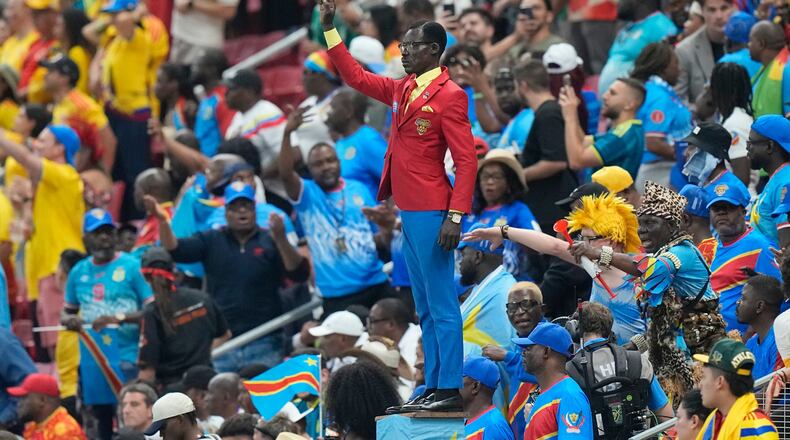 Congo supporter Michel Nkuka Mboladinga poses as a statue of the country's assassinated independence hero Patrice Lumumba ahead of the World Cup match against Colombia in Mexico on Tuesday, June 23, 2026. (Fernando Llano/AP)