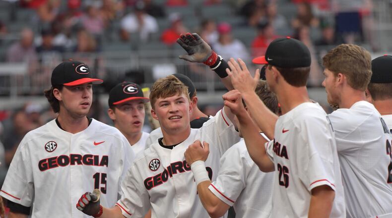 Georgia’s Aaron Schunk (22) is congratulated by teammates after he hit a home run against Georgia Tech at SunTrust Park on Tuesday, May 8, 2018. HYOSUB SHIN / HSHIN@AJC.COM