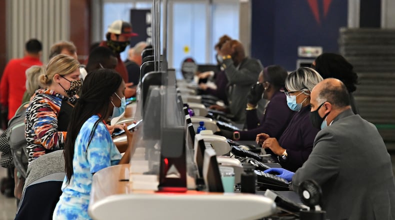 October 5, 2021 Atlanta - Delta Air Lines employees work the ticket counter in the Domestic Terminal at Hartsfield-Jackson Atlanta International Airport in Atlanta on Tuesday, October 5, 2021. (Hyosub Shin / Hyosub.Shin@ajc.com)