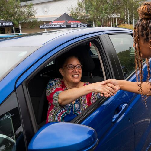 A DeKalb Public Health nurse greets Lynn Paxton, interim district health director, at a senior center in Lithonia in September 2025. Nurses were there to administer seasonal flu vaccines. (Olivia Bowdoin for the AJC)