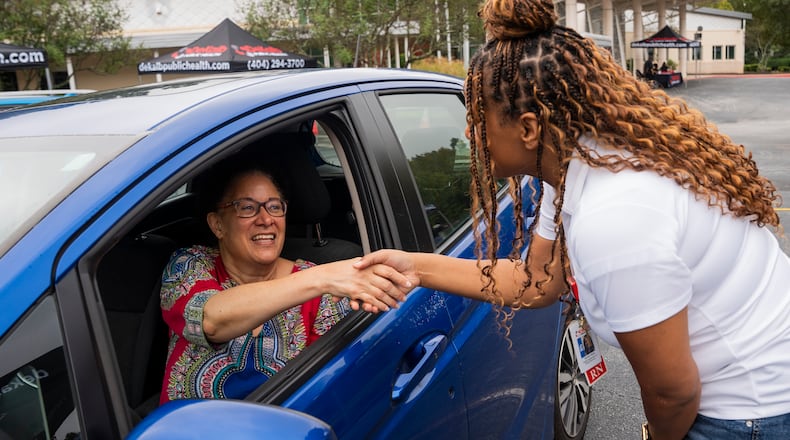 A DeKalb Public Health nurse greets Lynn Paxton, interim district health director, at a senior center in Lithonia in September 2025. Nurses were there to administer seasonal flu vaccines. (Olivia Bowdoin for the AJC)
