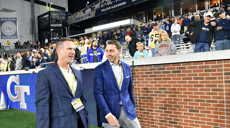 Incoming athletic director J Batt (right) talks with interim athletic director Frank Neville before their game against Virginia at Georgia Tech's Bobby Dodd Stadium in Atlanta on Thursday, October 20, 2022. (Hyosub Shin / Hyosub.Shin@ajc.com)