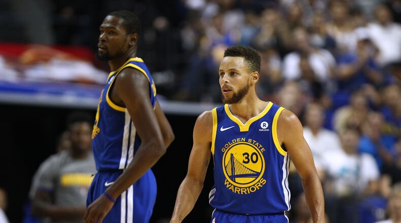 Stephen Curry #30 and Kevin Durant #35 of the Golden State Warriors look on during the game between the Minnesota Timberwolves and the Golden State Warriors as part of 2017 NBA Global Games China at Mercedes-Benz Arena on October 8, 2017 in Shanghai, China.