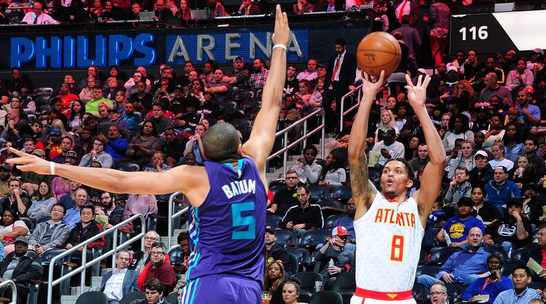 The Hawks’ Damion Lee scores on a corner 3-pointer over the Hornets’ Nicolas Batum during Thursday’s game at Philips Arena.