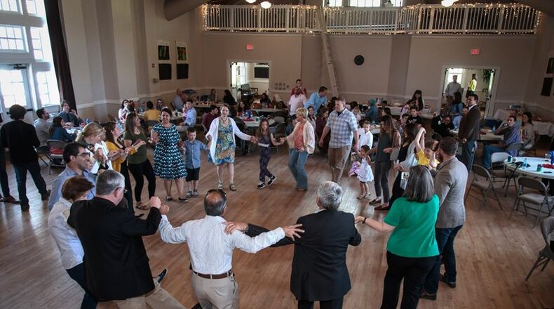 A crowd participated in a traditional Kurdish dance during a luncheon organized by local American military veterans and Atlanta-area Syrian refugees Sunday in Clarkston on April 9, 2017. STEVE SCHAEFER / SPECIAL TO THE AJC